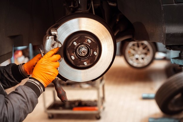 Mechanic Replacing Brake Pads on a European Car in Brisbane
