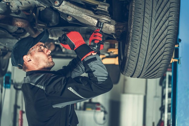 Mechanic Inspecting Suspension Problems in Workshop for European Cars in Brisbane